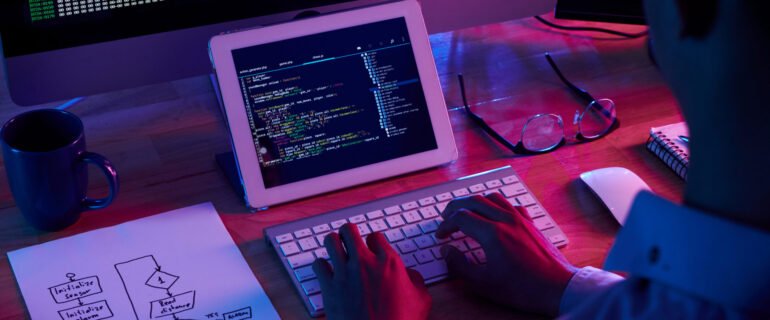 Programmer working at IT company office late at night